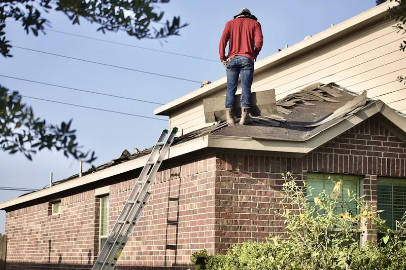 Professional roofer working on a residential roof in Menominee